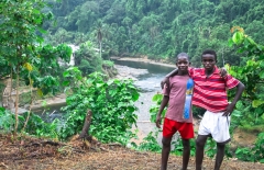 A pair of local afro-ecuadorian boys poses above the town of Wimbi and the Wimbi River, northwest Ecuador.