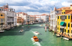 Boats race up and down the main canal in Venice, Italy.